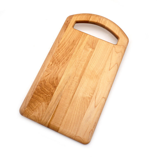 Maple cutting board with oval handle.