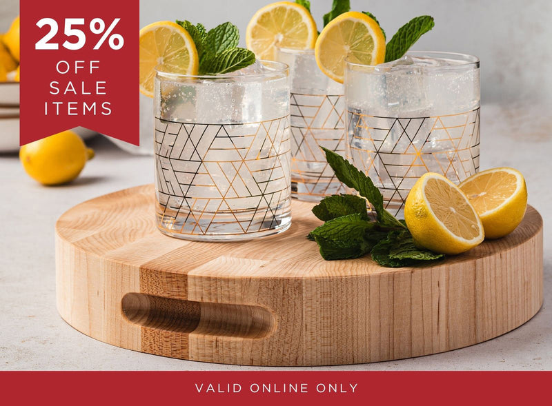 Three geometric-patterned glasses on a wooden board with lemons and mint leaves, promotional banner for 25% off sale items.