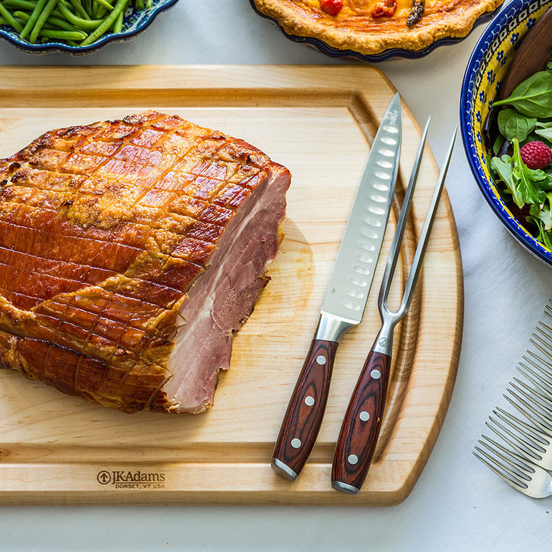 JK Adams maple reversible carving board with a glazed ham