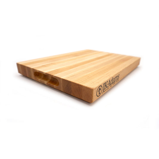 Wooden cutting board with 'IK Adams' branding on a white background