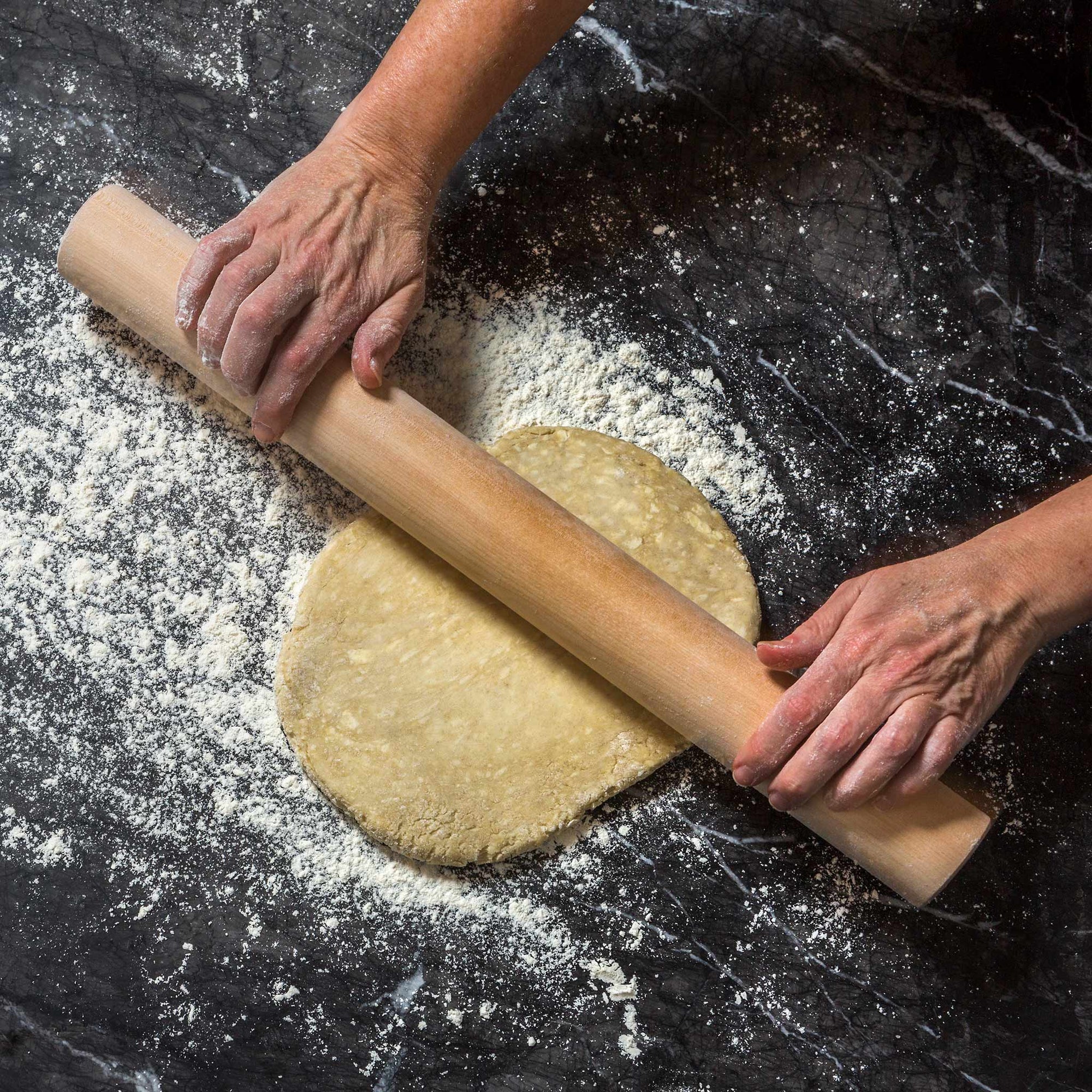 person handling dough