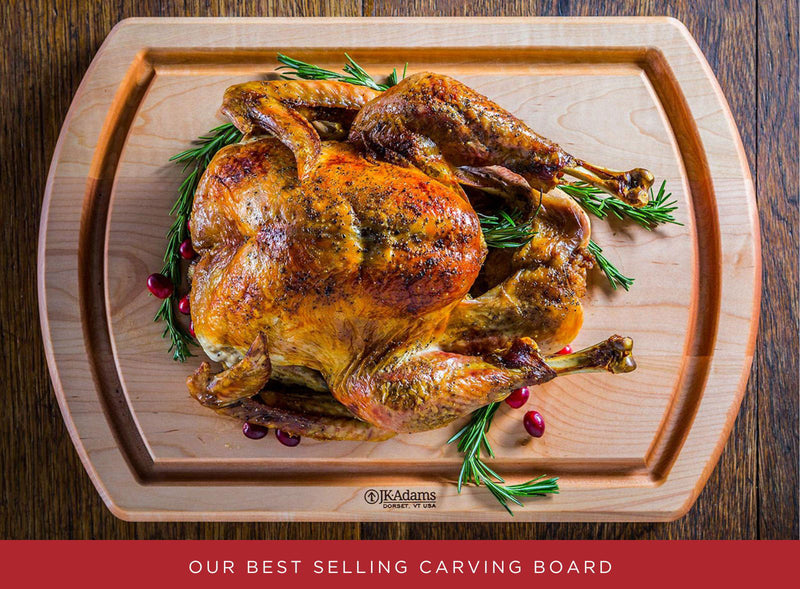Roasted turkey on a wooden carving board with J.K. Adams branding.