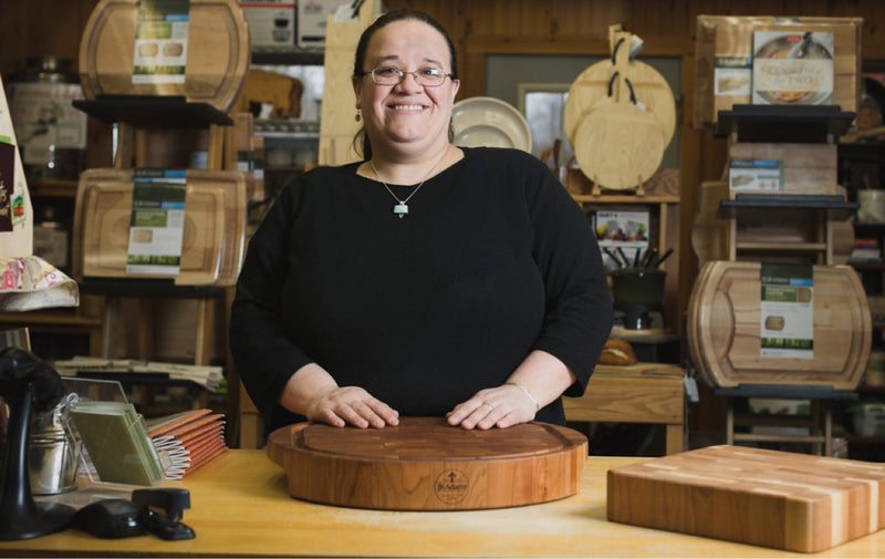 person in front of a cutting board