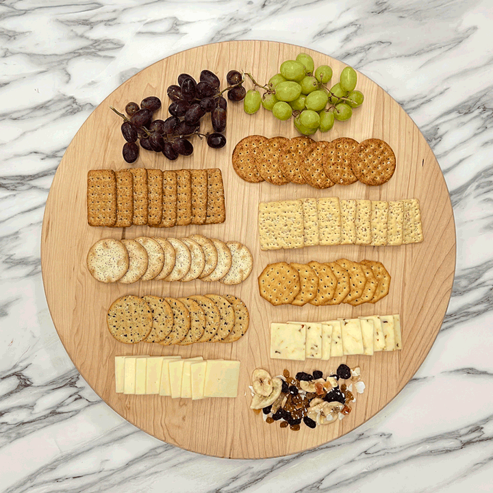 GIF Maple Lazy Susan spinning on a marble countertop with cheese and crackers.