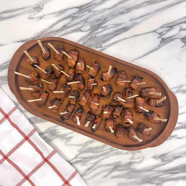 Bacon Wrapped Dates on a cherry oval serving tray