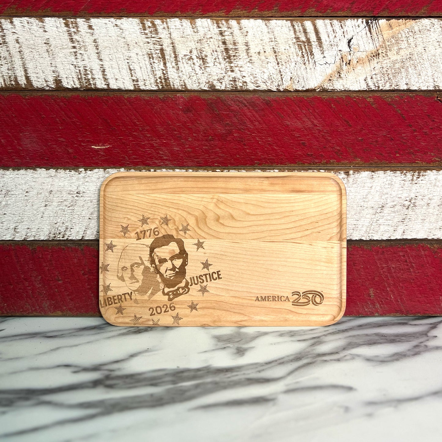 Maple appetizer tray engraved with the image of George Washington and Abraham Lincoln against red and white stripes.