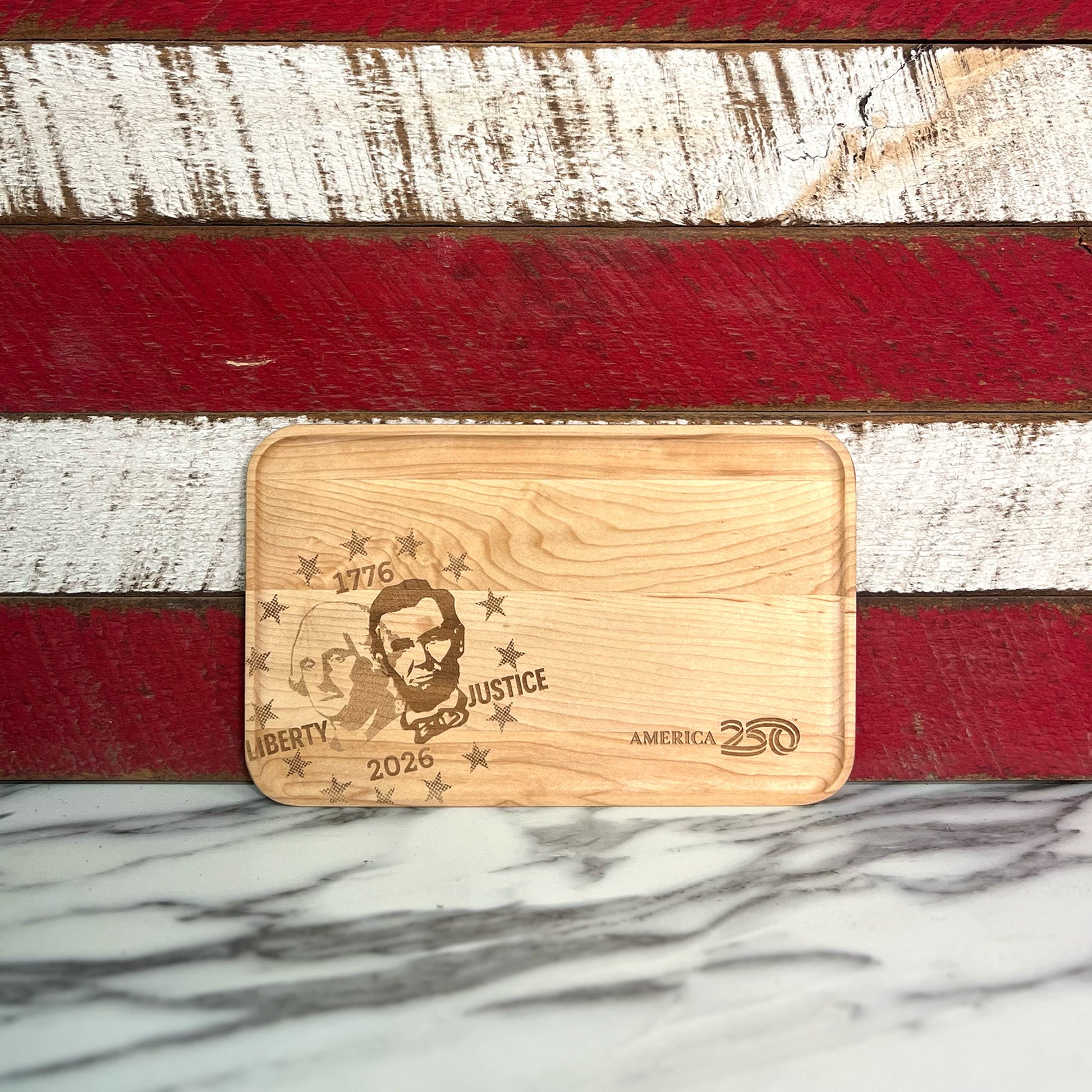Maple appetizer tray engraved with the image of George Washington and Abraham Lincoln against red and white stripes.