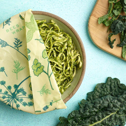 A bowl of pesto pasta wrapped in Bee's Wrap Herb Garden.
