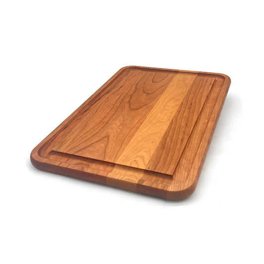 Angled view of a cherry prep board with a juice groove. 