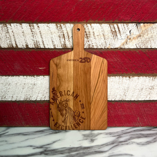 Wooden cutting board with 'American Excellence' engraving on a red and white striped background