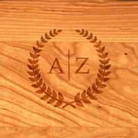 Wooden surface with engraved initials 'A' and 'Z' surrounded by a leaf design.