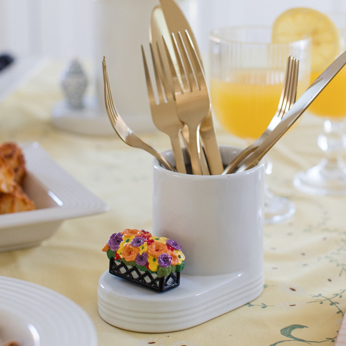 Nora Fleming white crock with sliverware and a window box mini.