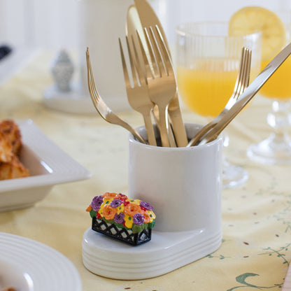 Nora Fleming white crock with sliverware and a window box mini.