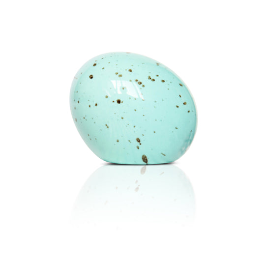 Turquoise speckled egg, Nora Fleming mini, on a white background 
