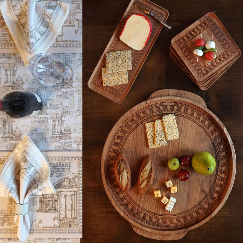 Ramsay Gourd Collection Cherry serving pieces with Roman Holiday engraving and roman holiday linen runner. 
