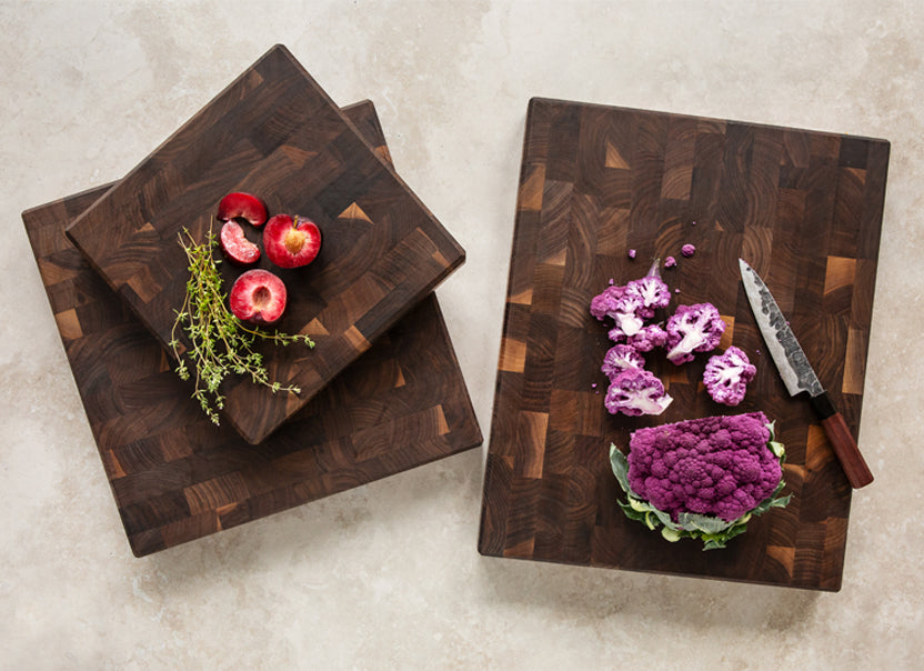 JK Adams Professional Walnut Cutting boards with purple cauliflower and plums.