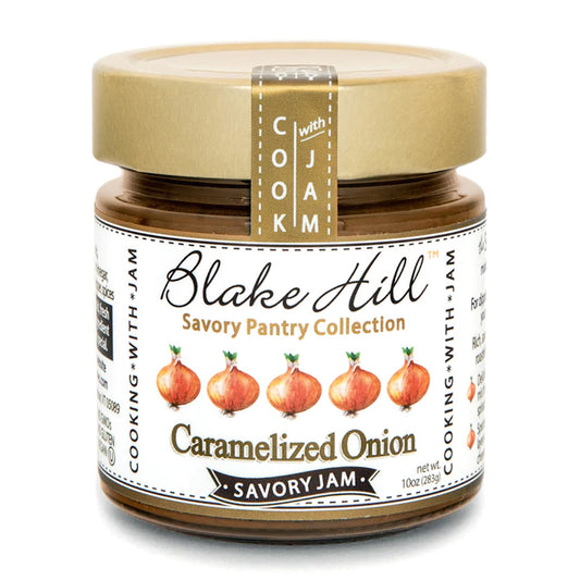 A jar of Blake Hill Savory Jam from the Savory Pantry Collection, featuring Caramelized Onion flavor. The label shows images of onions and emphasizes Cook with Jam. The jar contains 10 oz (283g).