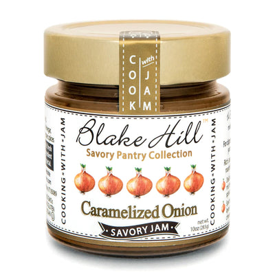 A jar of Blake Hill Savory Jam from the Savory Pantry Collection, featuring Caramelized Onion flavor. The label shows images of onions and emphasizes Cook with Jam. The jar contains 10 oz (283g).