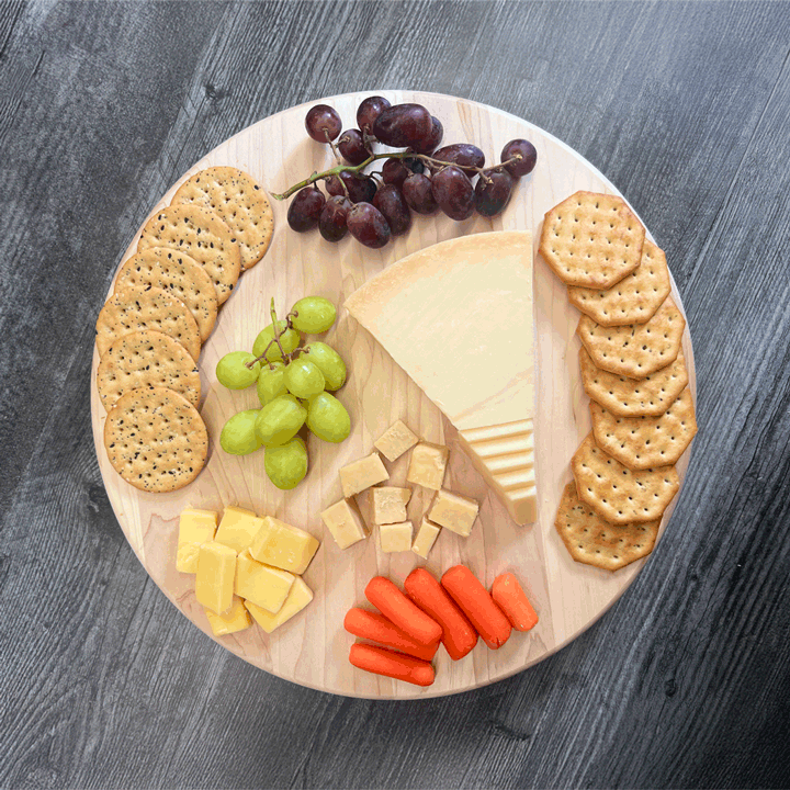 GIF of Lazy Susan turning with cheese, crackers, fruits and veggies