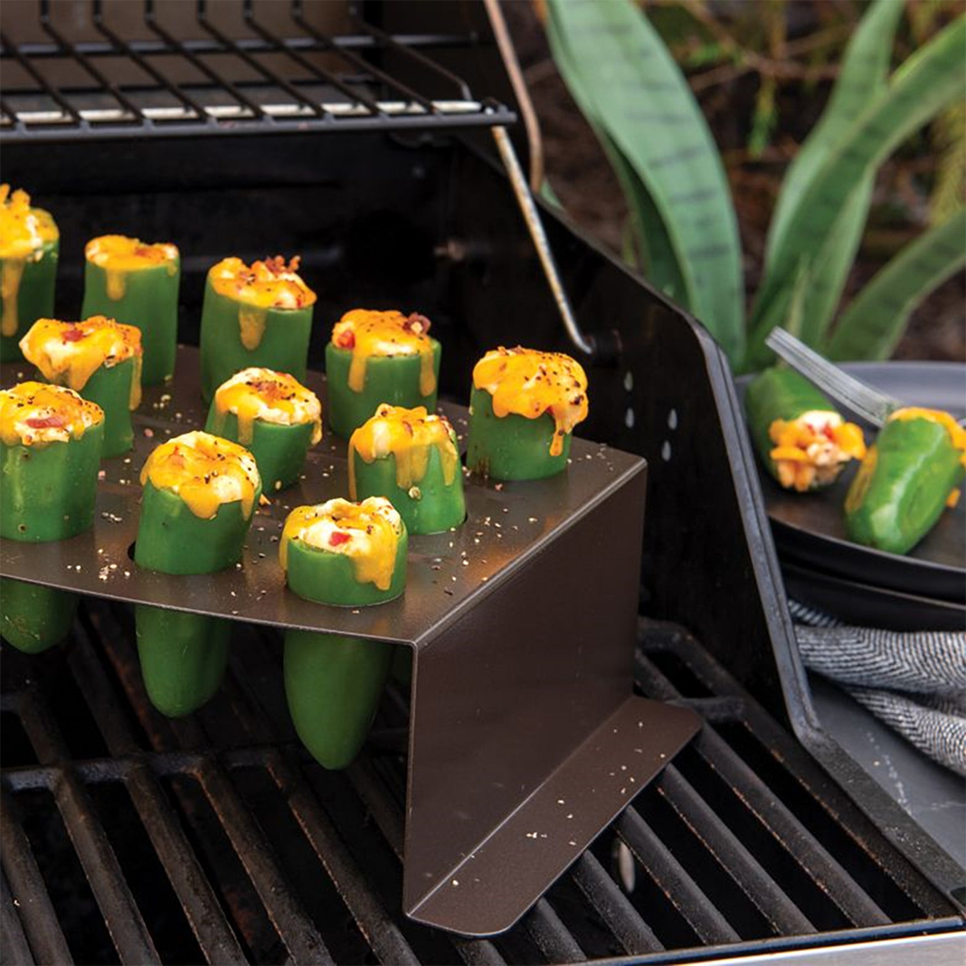 https://www.jkadams.com/cdn/shop/files/jk-adams-nordic-ware-chicken-leg-griller-lifestyle-jalepenos.jpg?v=1684786938&width=1946